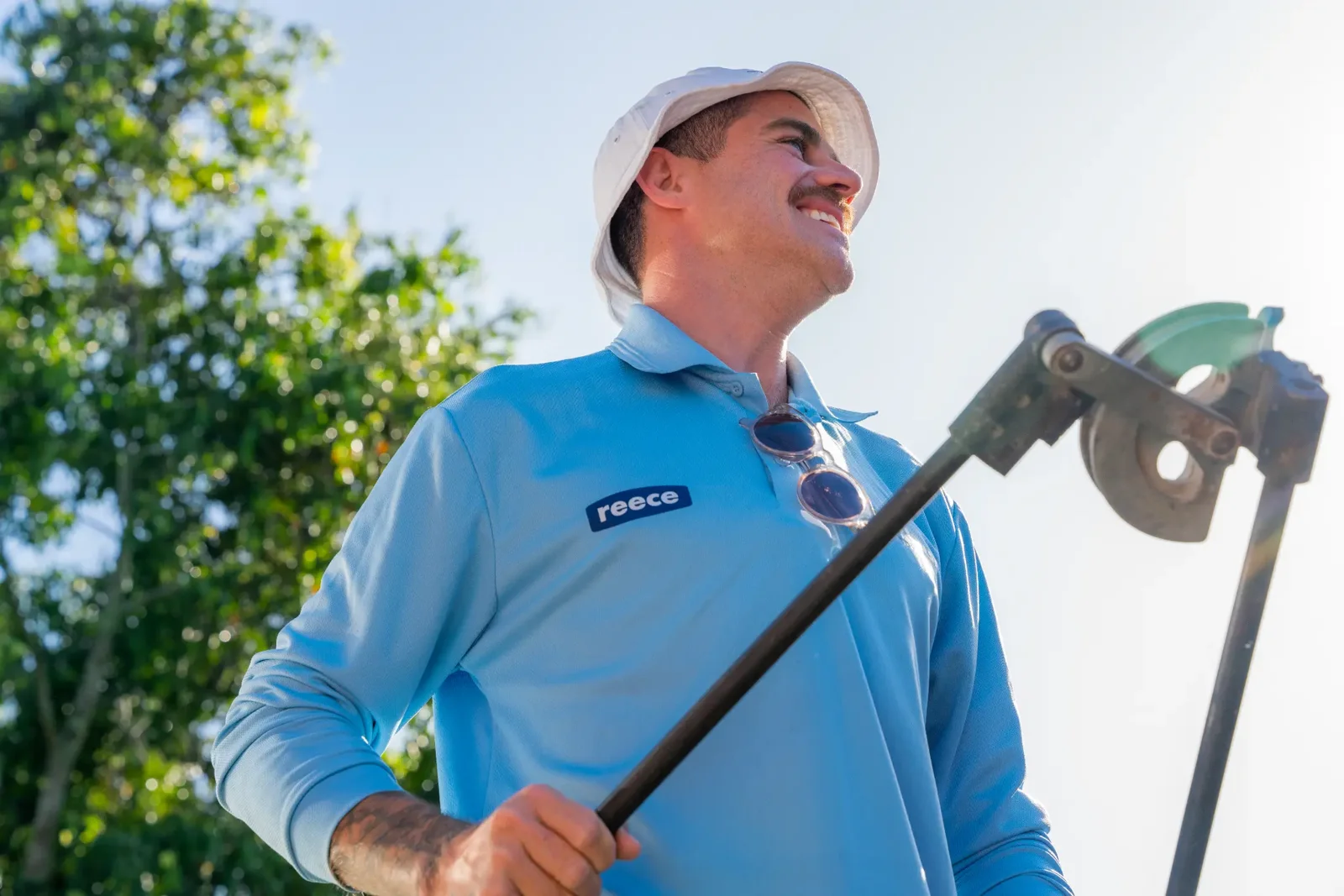 Gold Coast commercial maintenance plumber Nic carrying a pipe cutter on site between scheduled service visits